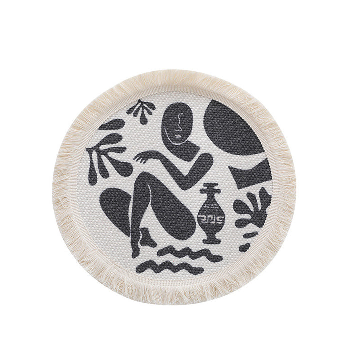 Round woven placemat with fringes and abstract figure motif Kalsten