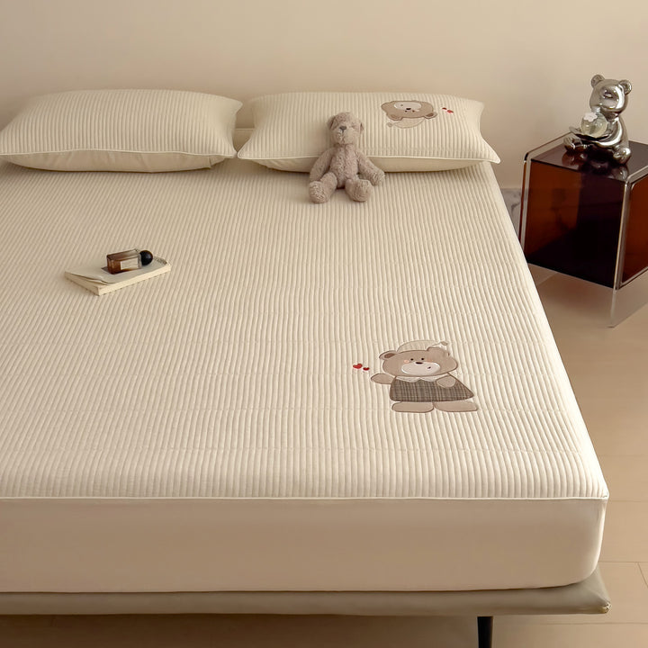 Quilted mattress topper with bunny applique and non-slip bottom