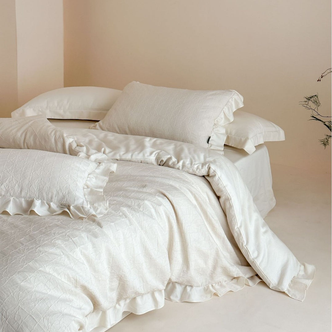Quilted cotton-linen duvet cover set with subtle wrinkled texture and ruffle