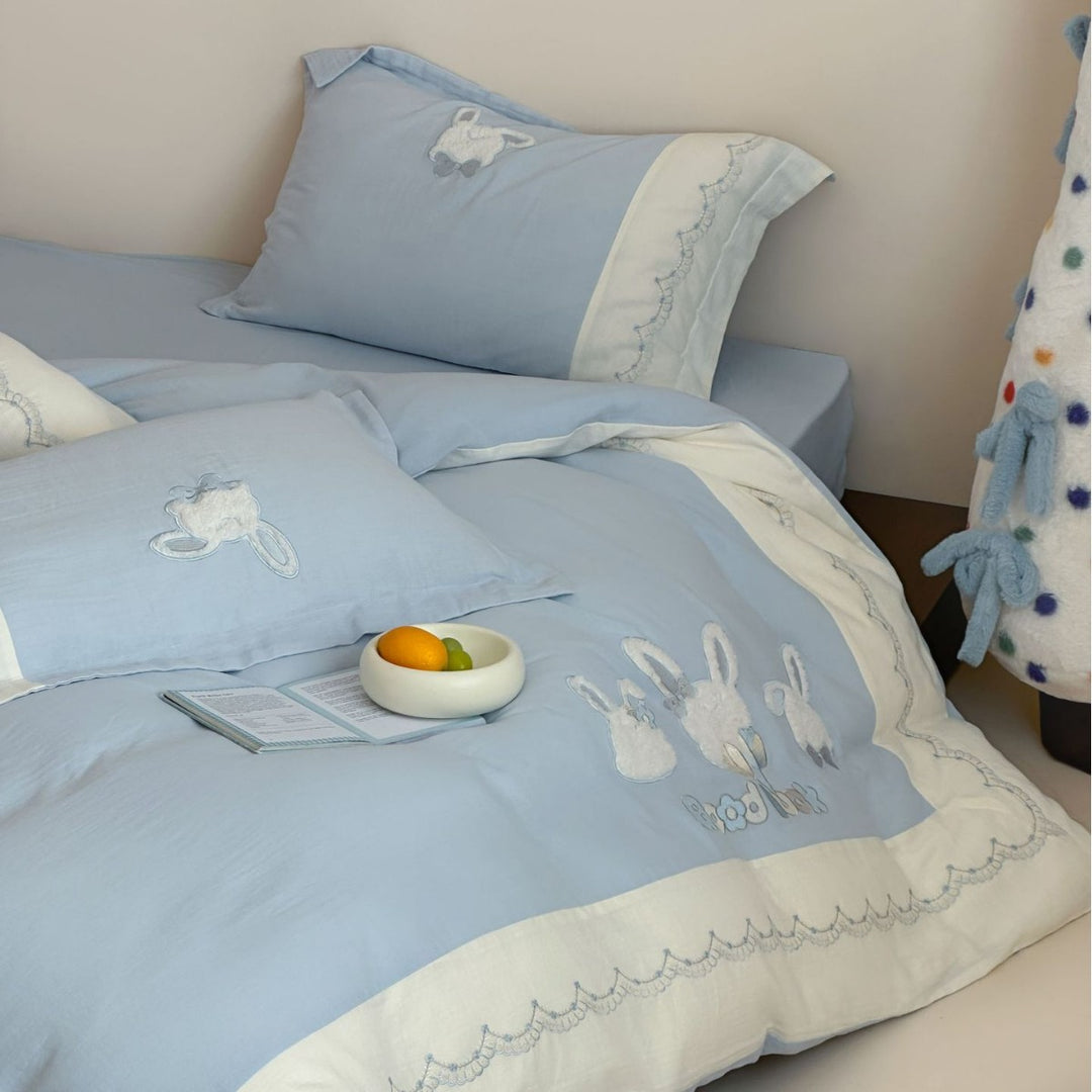 Embroidered cotton satin bedding set with appliquéd rabbit designs and decorative border