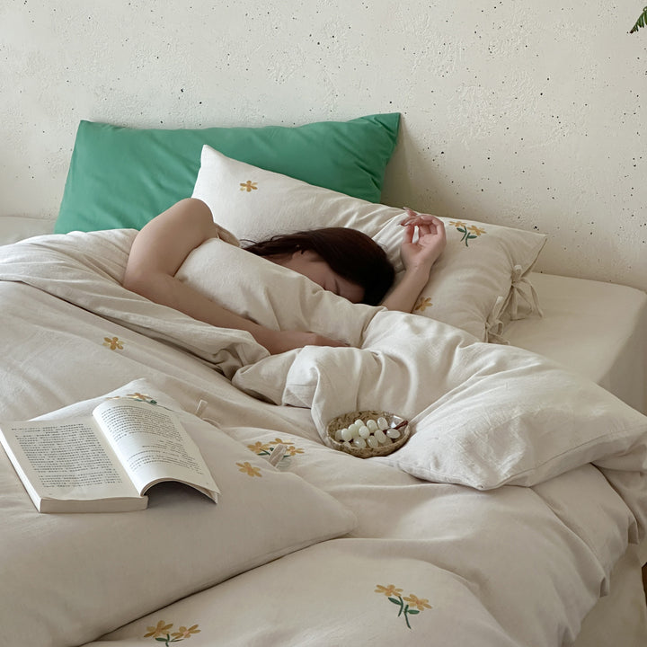 Natural linen duvet cover set with embroidered floral motifs and bow closure