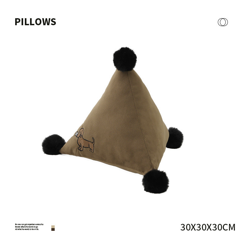 Pyramid-shaped triangle cushion with faux fur pom-poms and zebra embroidery