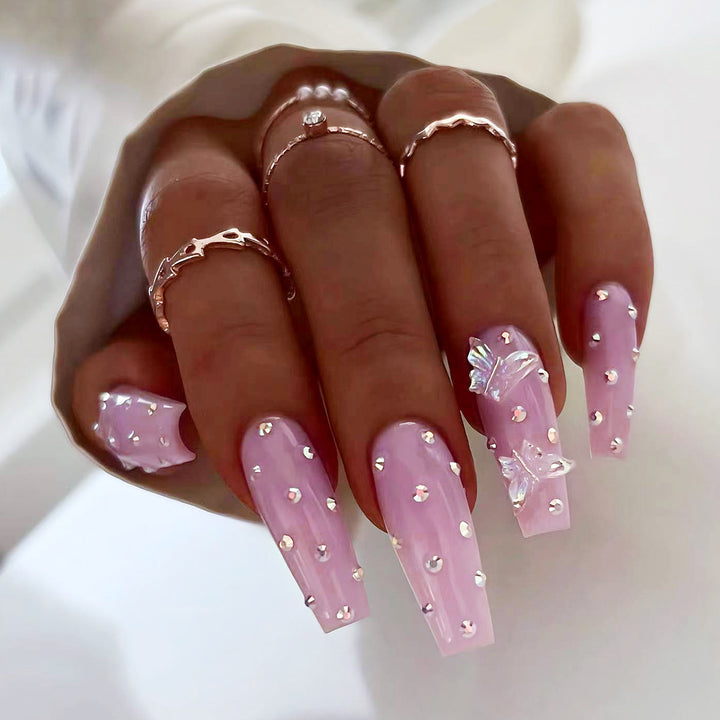 Artistic nail extensions with rhinestone and butterfly adornments Kalsten