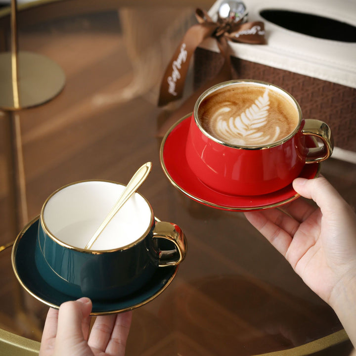 Elegant porcelain cup with saucer and sculptural gold handle