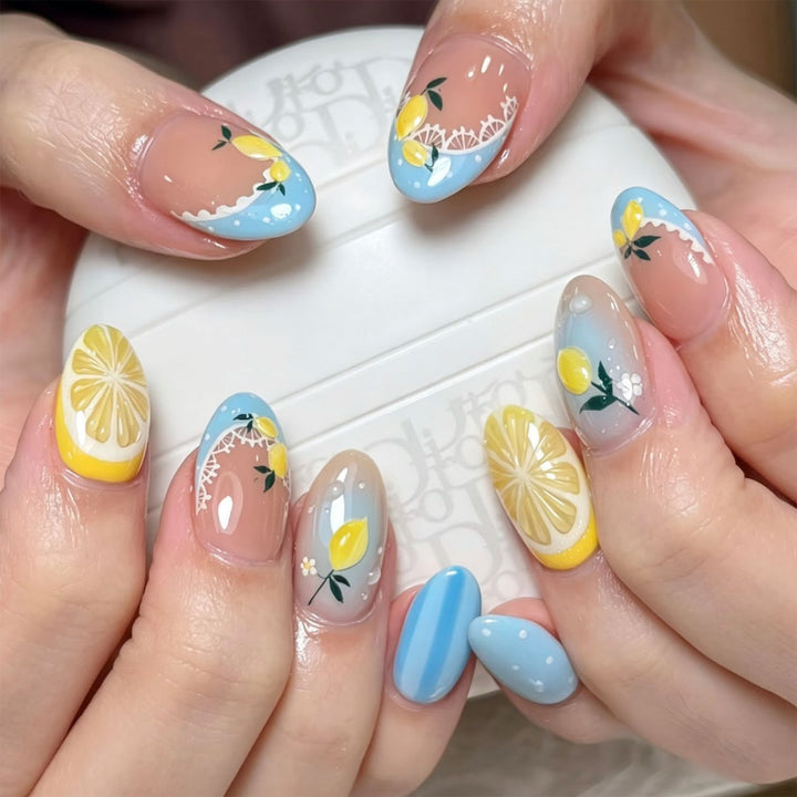 Artificial nail art with lemon and flower motifs Kalsten