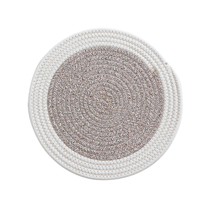 Round handwoven table placemat made of cotton yarn with structured spiral binding