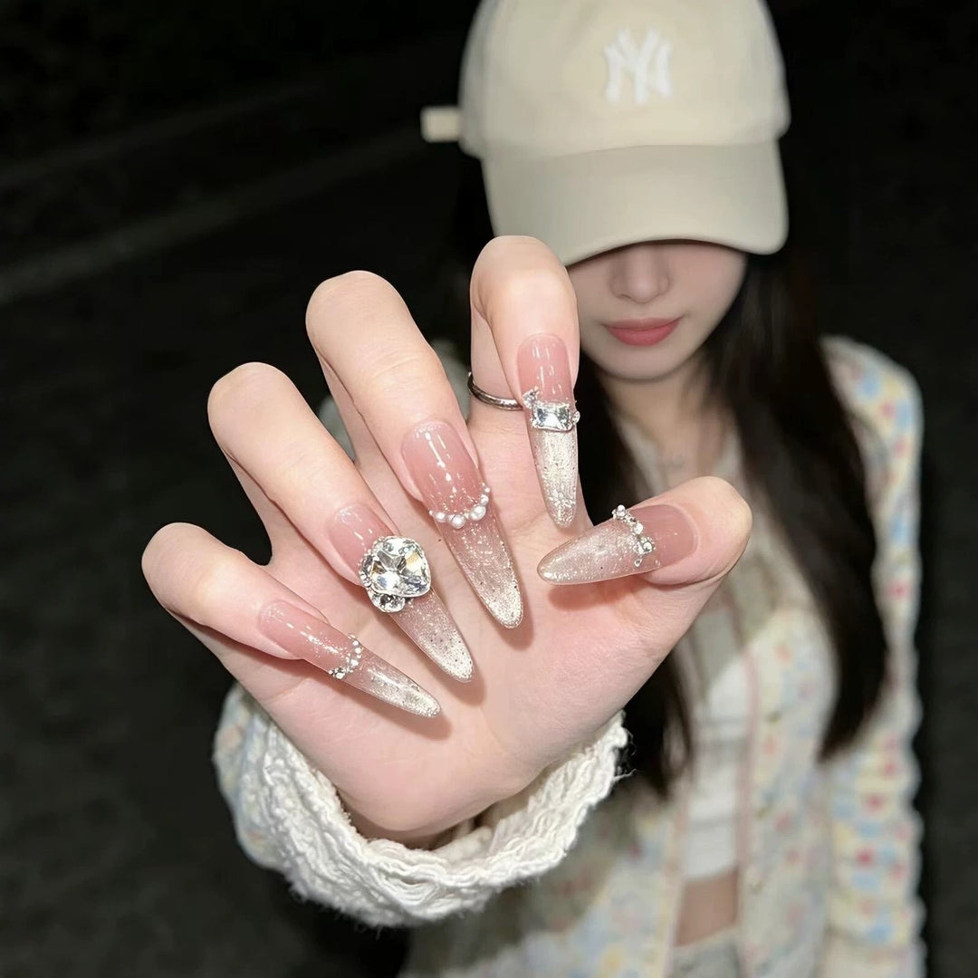 Artistic Stiletto Nail Enhancements with Gemstone Accents