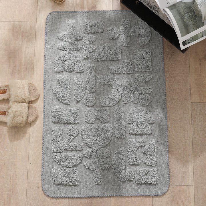 Rectangular cotton bath mat with abstract 3D tuft relief and non-slip back