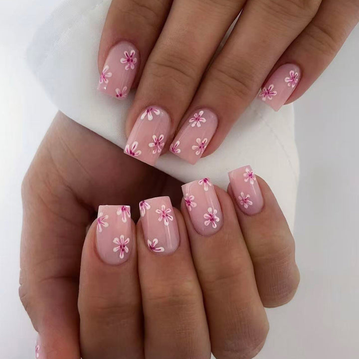 Artful Nail Art with Flower Design and Blue French Tip Kalsten