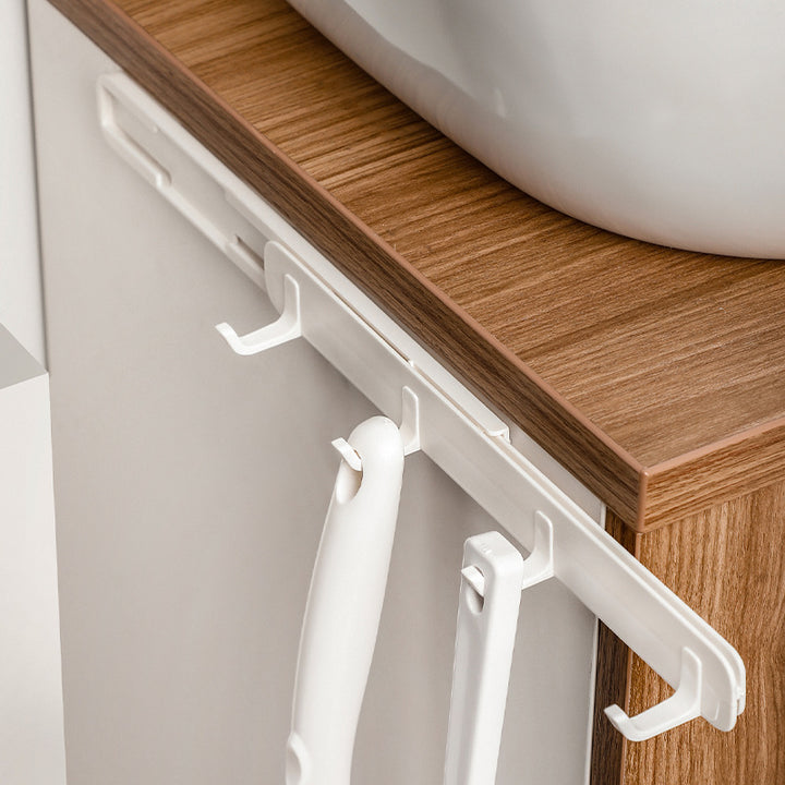 Wall hook strip with multiple rounded hooks and self-adhesive back
