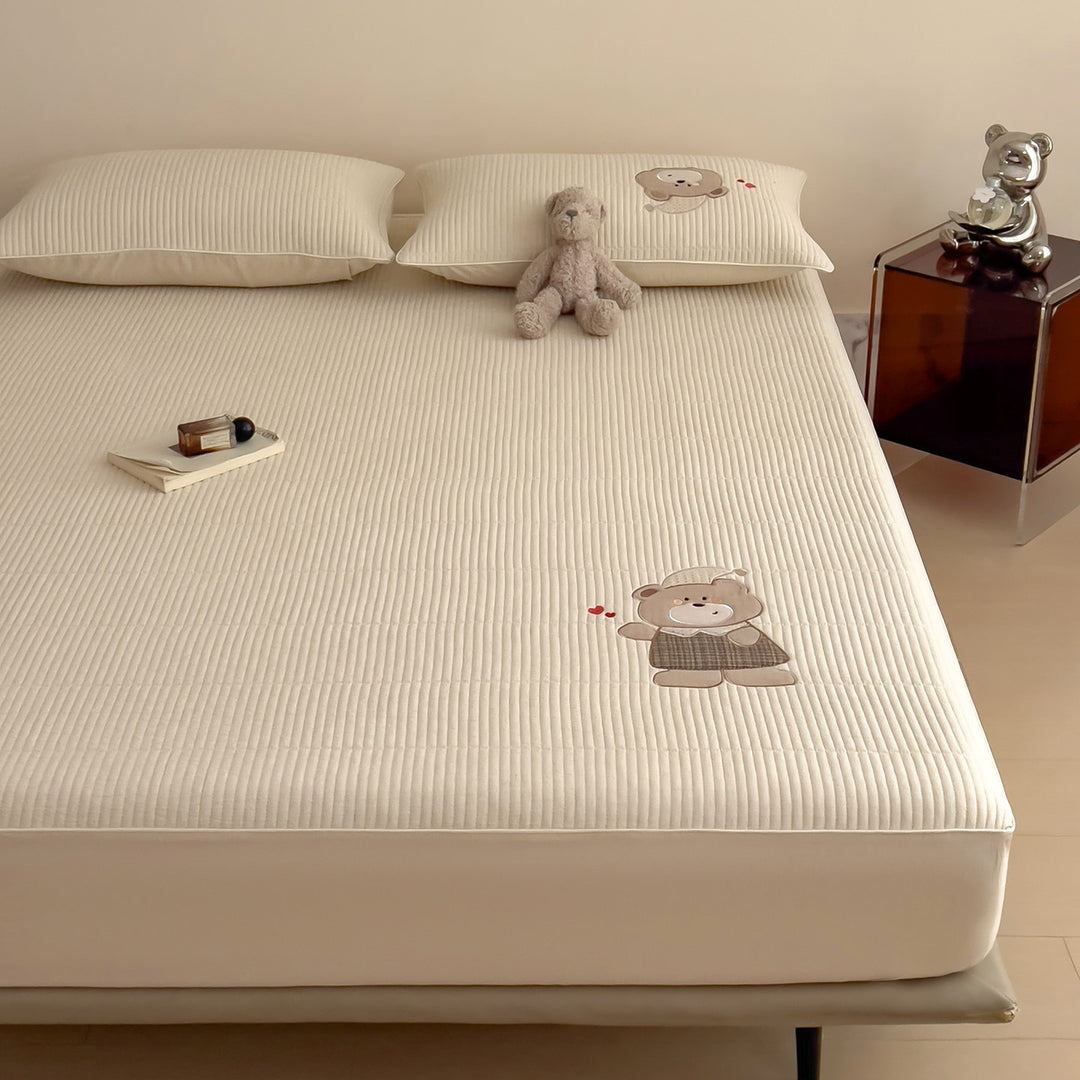 Quilted mattress topper with bunny applique and non-slip bottom