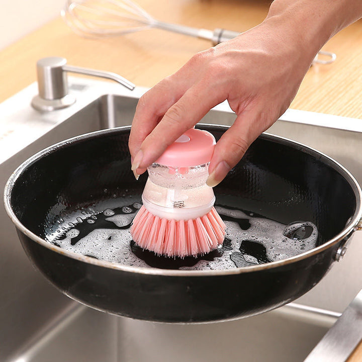 Dish brush with soap dispenser for pressing