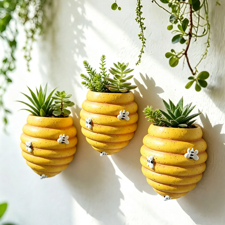 Wall-mounted flower pot with bee motif