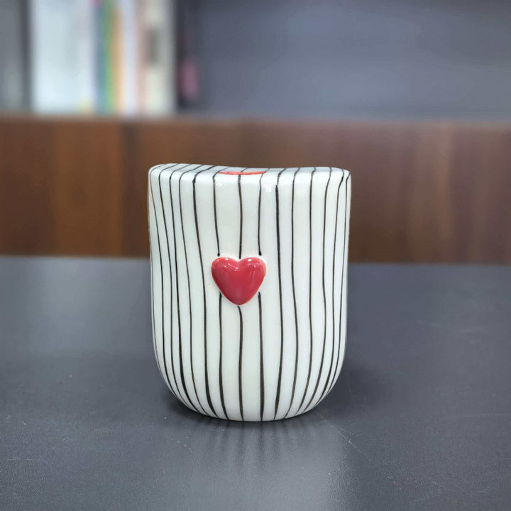 Ceramic coffee mug with stripes and heart design