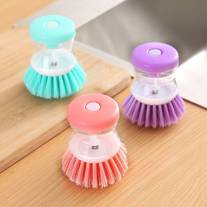 Dish brush with soap dispenser for pressing