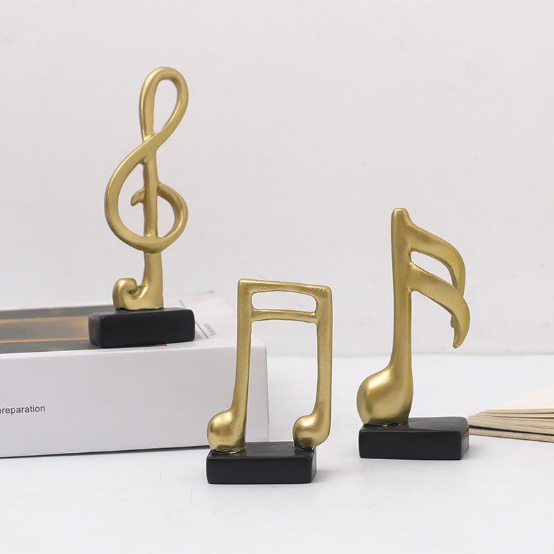 Three music note figures, resin, modern