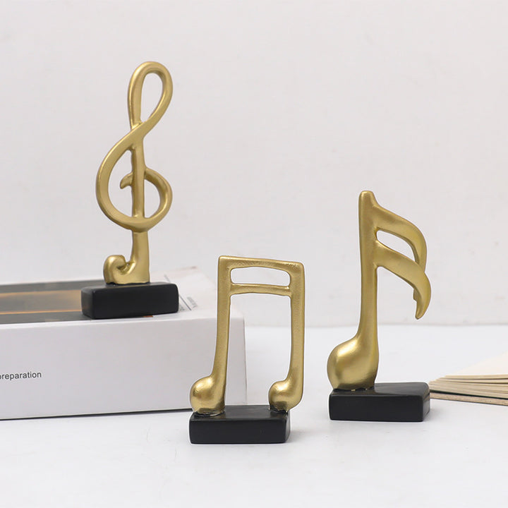 Three music note figures, resin, modern