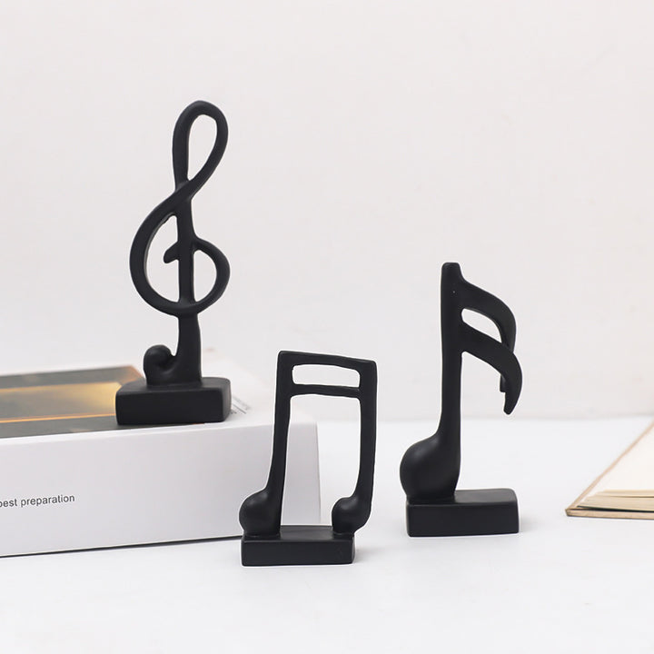 Three music note figures, resin, modern