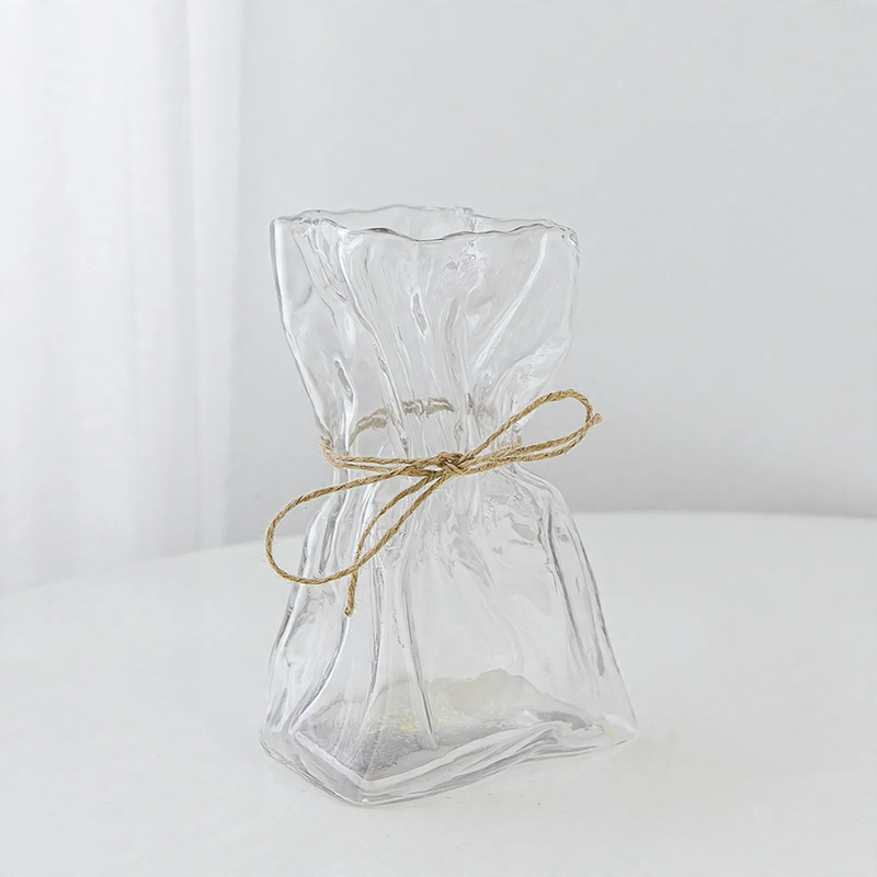 Glass vase with irregular folding pattern