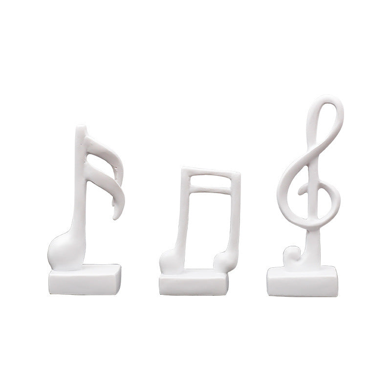 Three music note figures, resin, modern