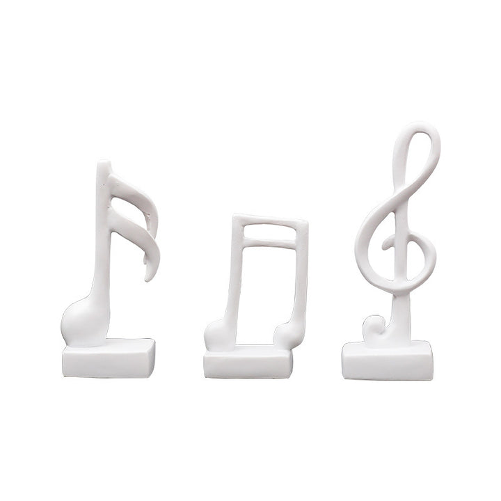 Three music note figures, resin, modern