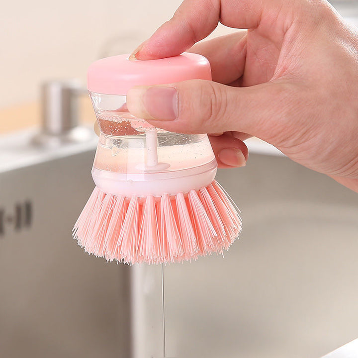 Dish brush with soap dispenser for pressing