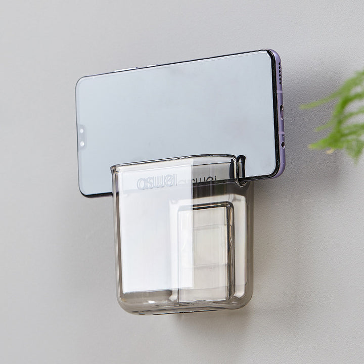 Wall-mounted storage box for remote controls and phones