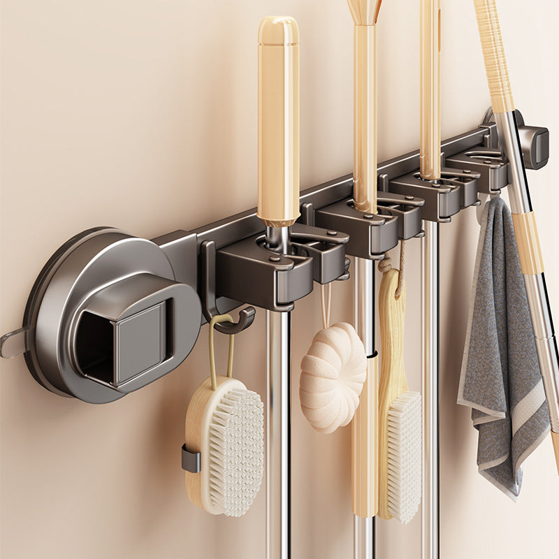 Suction cup holder for brooms and cleaning tools