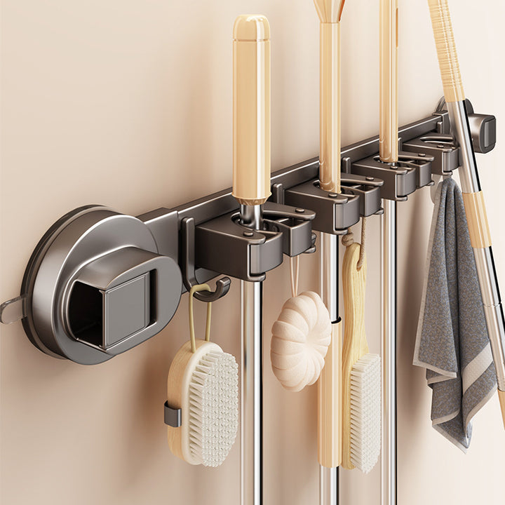Suction cup holder for brooms and cleaning tools