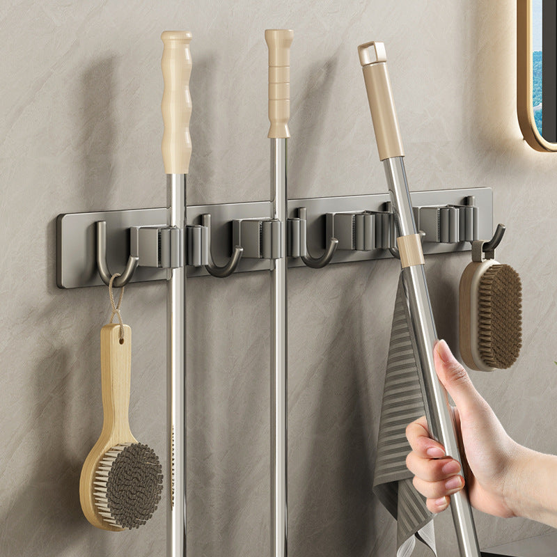 Wall bracket for brooms and mops made of stainless steel